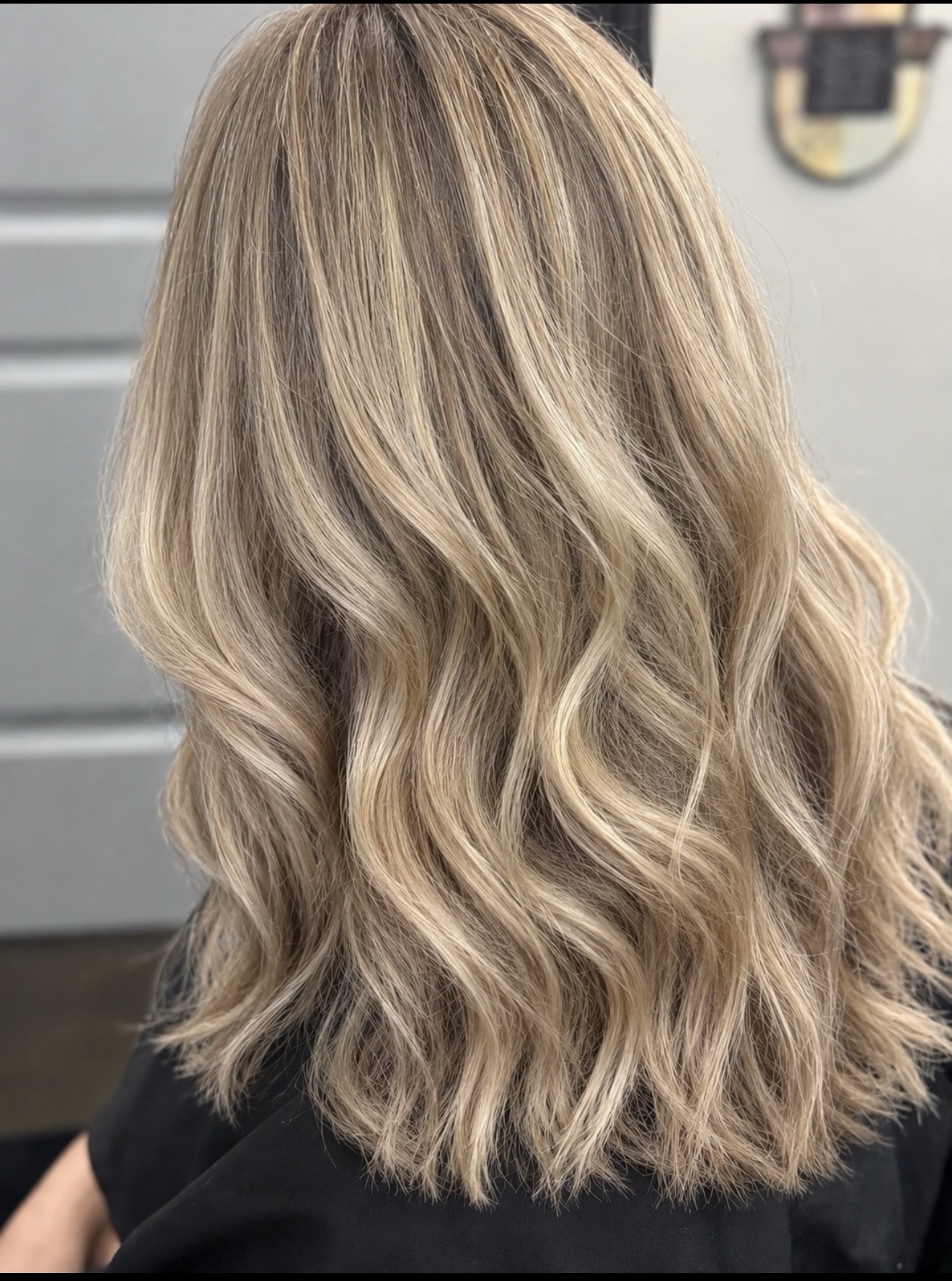 Champagne blonde bob styled in soft waves