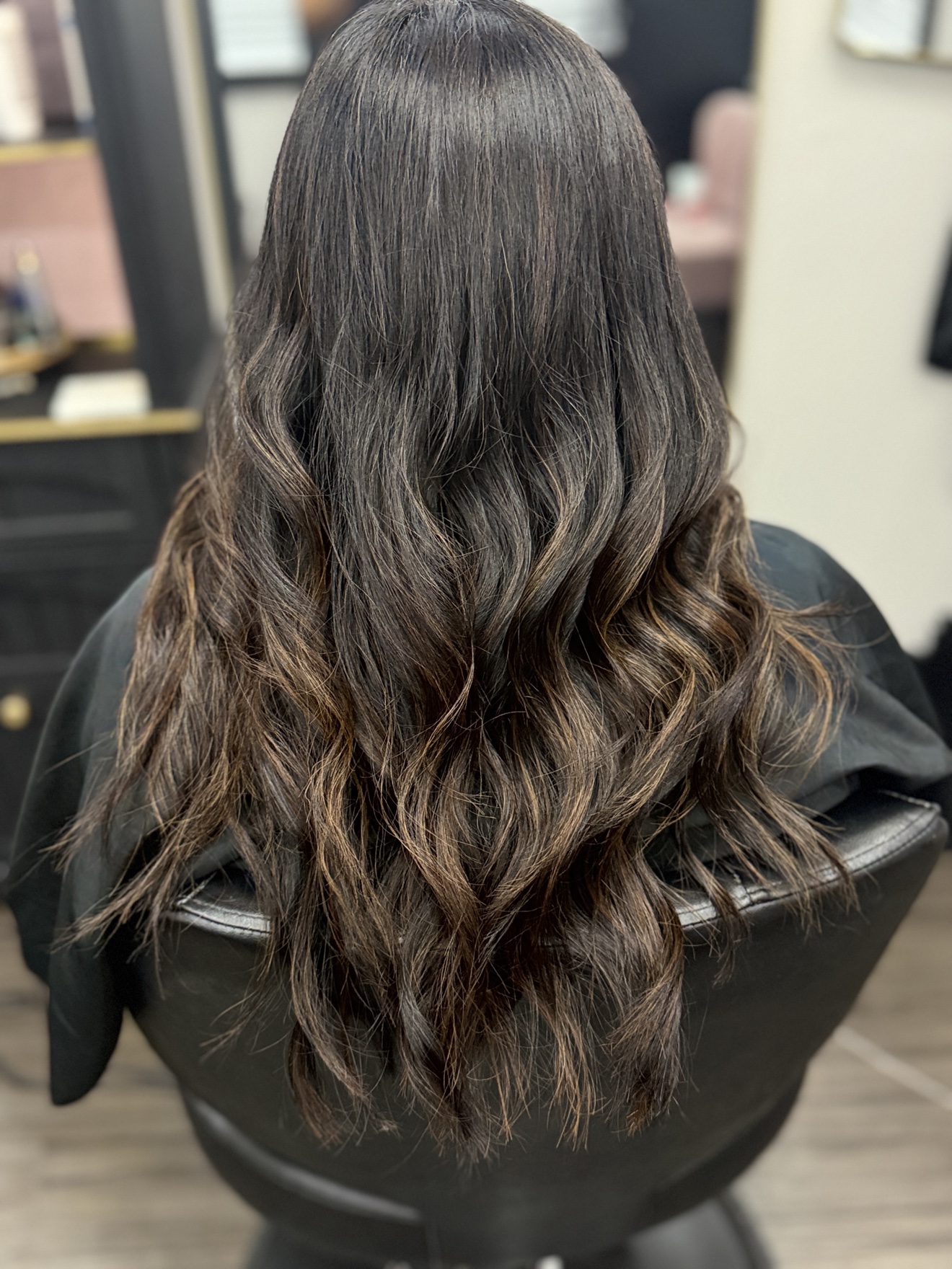 Long brunette hair styled in glossy waves