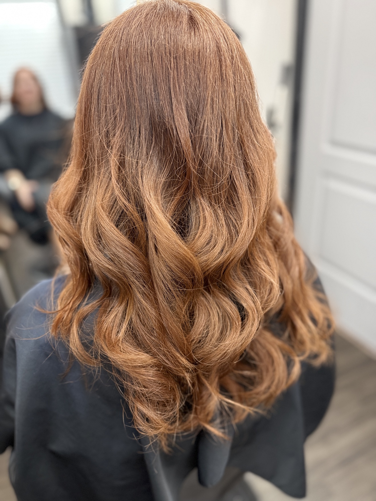 Copper hair styled in flowing waves